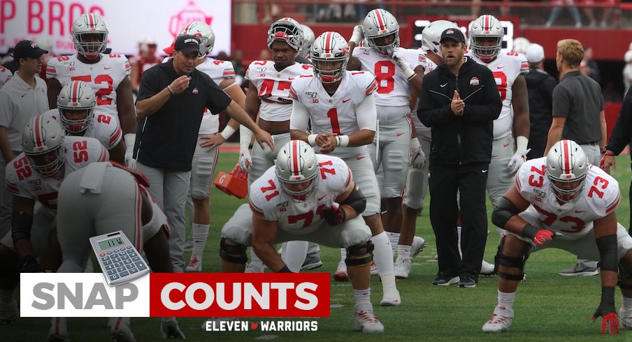 Justin Fields takes a snap from Josh Myers pregame.