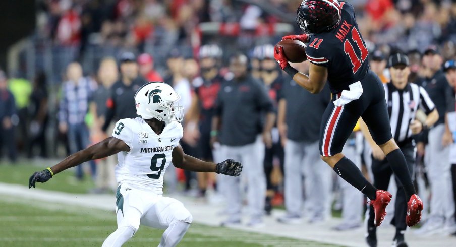 Austin Mack hauls in a back-shoulder fade to convert a third down against the Spartans.