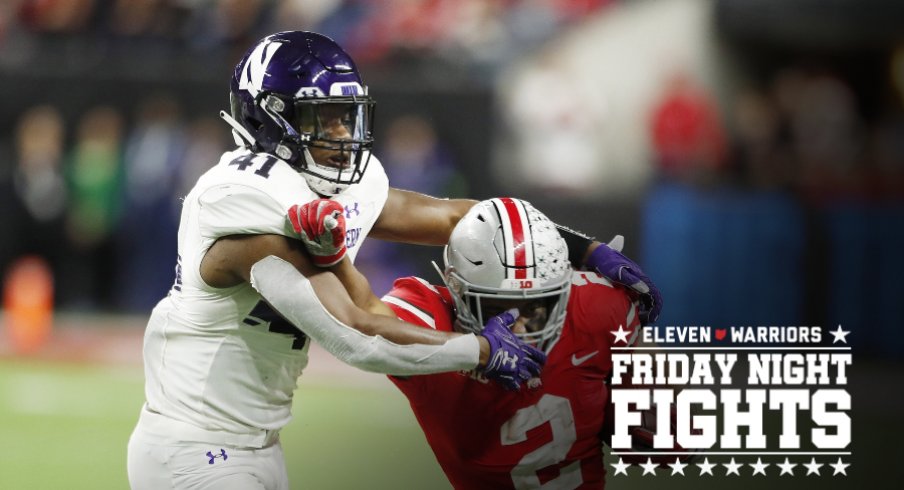 Dec 1, 2018; Indianapolis, IN, USA; Ohio State Buckeyes running back J.K. Dobbins (2) is tackled by Northwestern Wildcats safety Jared McGee (41) during the fourth quarter in the Big Ten conference championship game at Lucas Oil Stadium. Mandatory Credit: Brian Spurlock-USA TODAY Sports