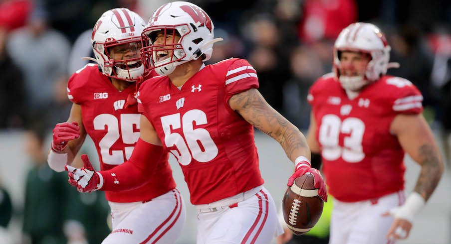 Zack Baun celebrates his interception return touchdown against Michigan State.