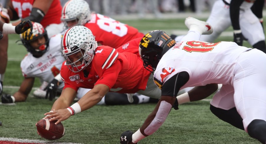 Justin Fields dives for the end zone. 