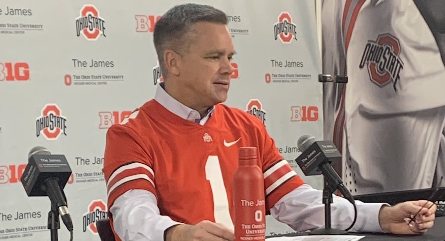 Chris Holtmann rocks a football jersey.