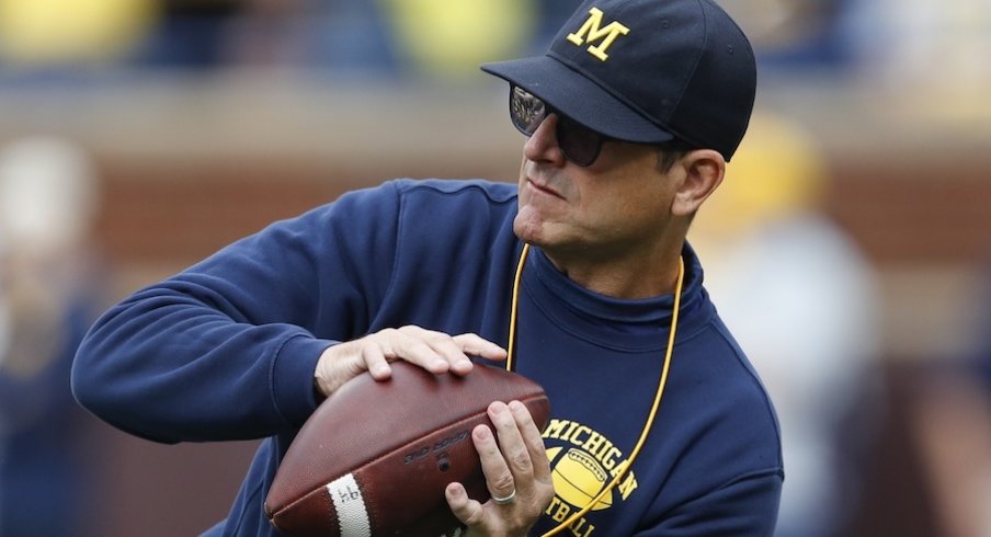 Sep 28, 2019; Ann Arbor, MI, USA; Michigan Wolverines head coach Jim Harbaugh catches a ball before the game against the Rutgers Scarlet Knights at Michigan Stadium. Mandatory Credit: Raj Mehta-USA TODAY Sports