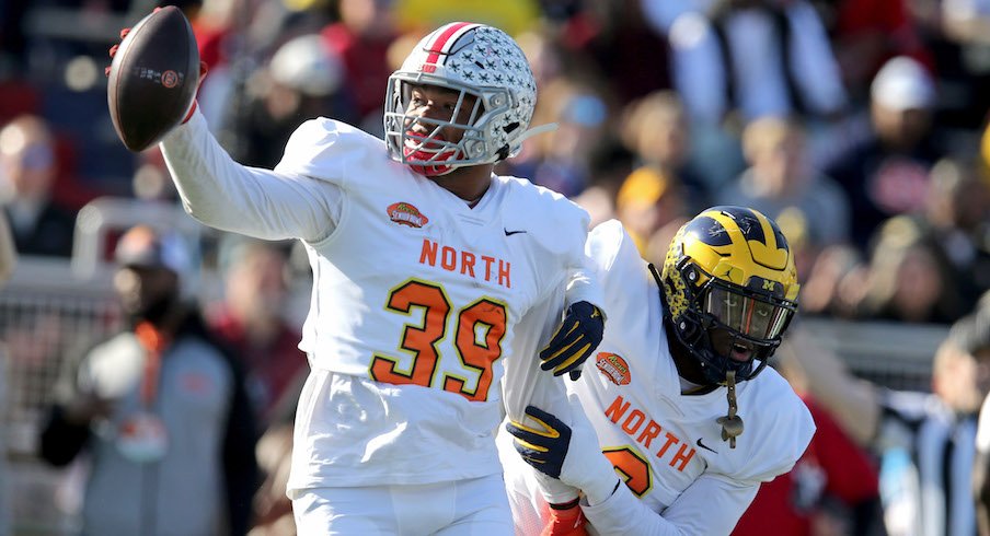 Malik Harrison celebrates his interception in the Senior Bowl.