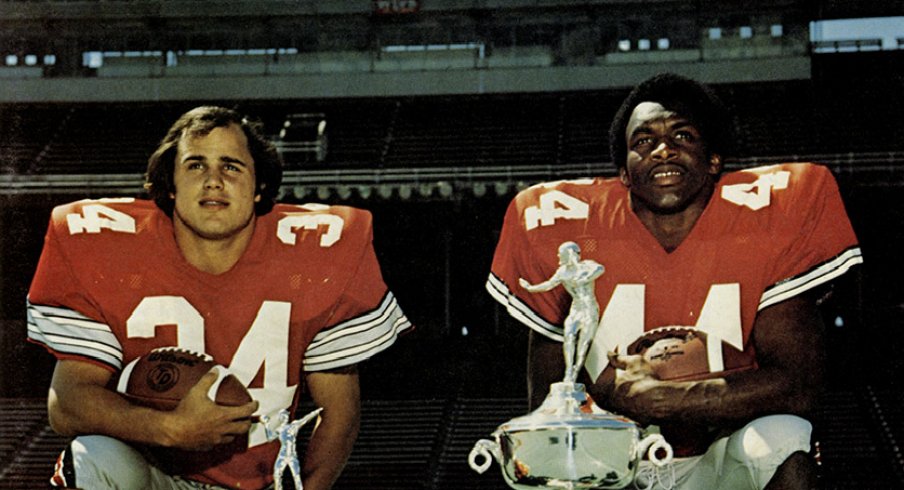 Running backs Jeff Logan and Archie Griffin pose with their trophies.