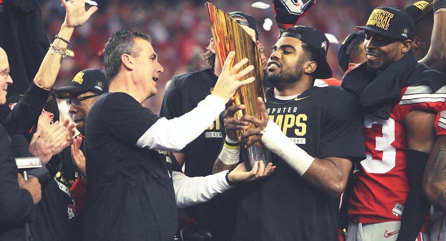 Urban Meyer and Ezekiel Elliott celebrate with the national championship trophy.