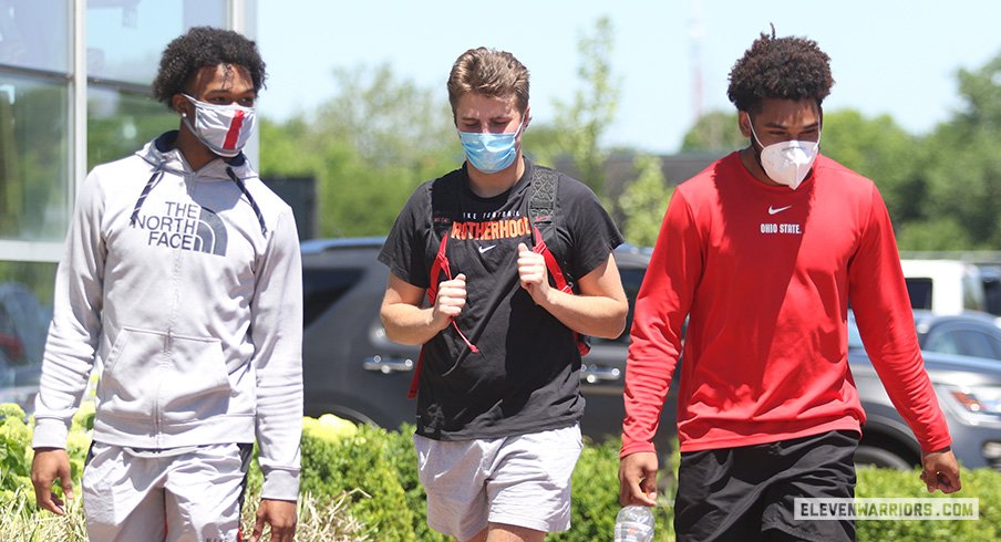 Garrett Wilson and Chris Olave report to the Woody Hayes Athletic Center.