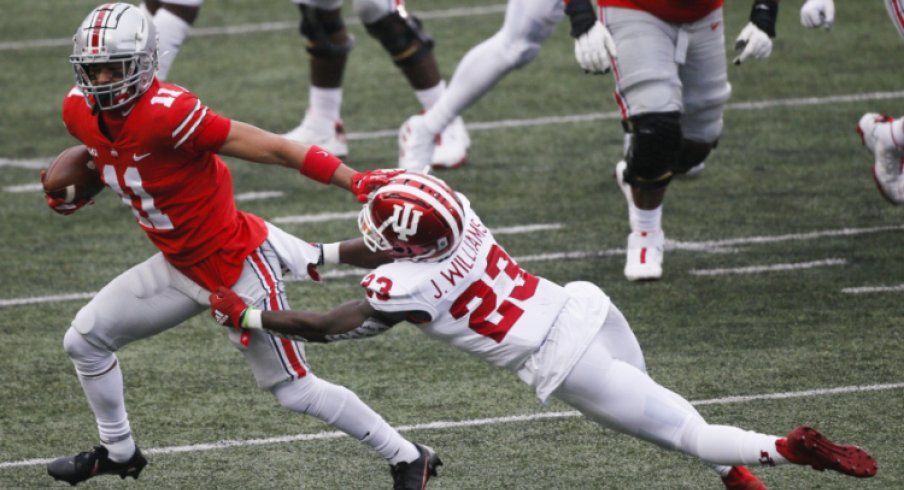 Ohio State Buckeyes wide receiver Jaxon Smith-Njigba (11) shakes off Indiana Hoosiers defensive back Jaylin Williams (23) as he fights for yards after a completion during the second quarter of a NCAA Division I football game between the Ohio State Buckeyes and the Indiana Hoosiers on Saturday, Nov. 21, 2020 at Ohio Stadium in Columbus, Ohio. Cfb Indiana Hoosiers At Ohio State Buckeyes