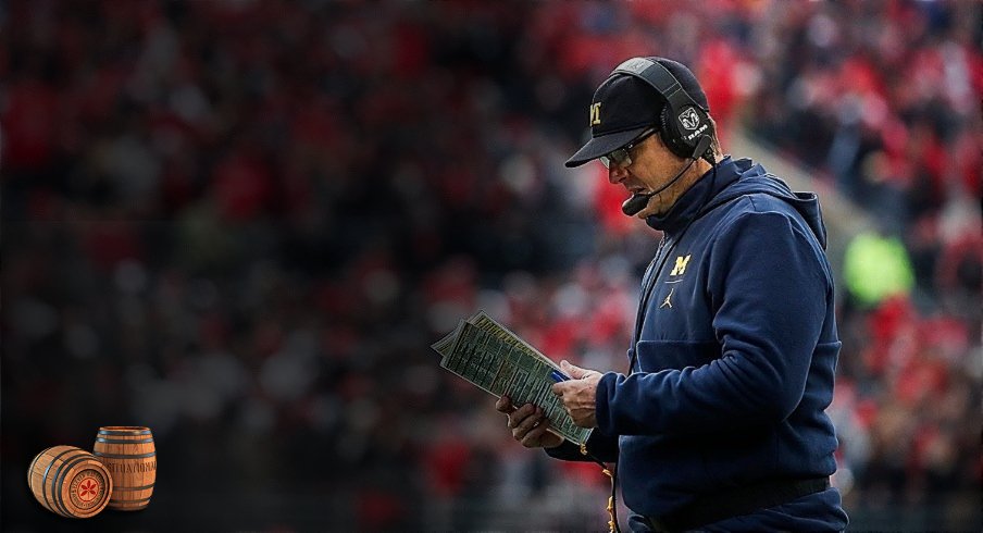 Michigan head coach Jim Harbaugh looks down at his notes during a timeout in the second half against Ohio State at Ohio Stadium in Columbus, Ohio, Saturday, Nov. 24, 2018. Jim Harbaugh
