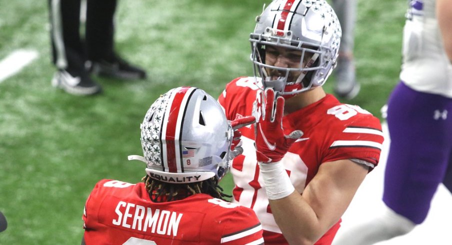 Ohio State football players Trey Sermon and Jeremy Ruckert celebrate a Big Ten championship