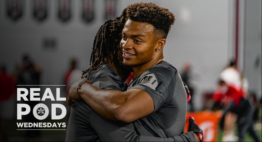 Justin Fields smiles and hugs Trey Sermon after his pro day workout.