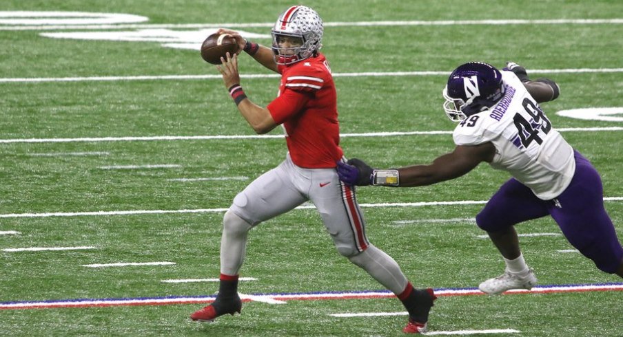 Ohio State quarterback Justin Fields escapes a Northwestern defender