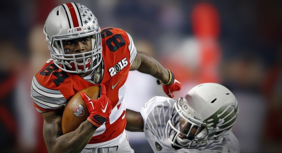 Ohio State Buckeyes wide receiver Corey Smith (84) gets away from Oregon Ducks defensive back Reggie Daniels (8) after making a pass during the 2nd quarter in College Football Playoff Championship game at AT&T Stadium in Arlington, Texas on January 12, 2015. Smith then fumbles the ball and loses it to Oregon Ducks. (Dispatch photo by Kyle Robertson)