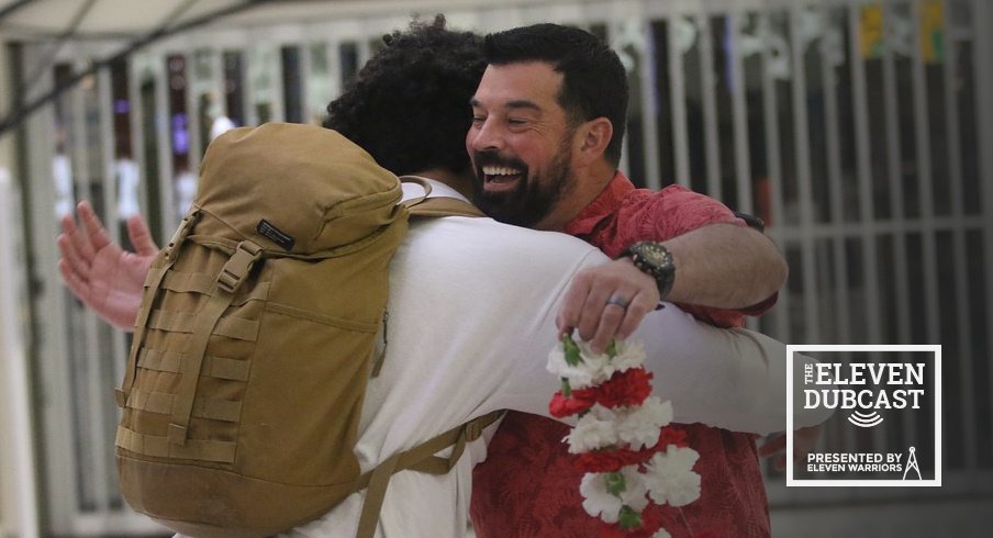 Ohio State head coach Ryan Day hugs a recruit