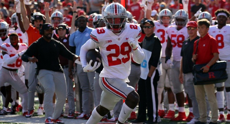 Denzel Burke returns an interception for a touchdown.