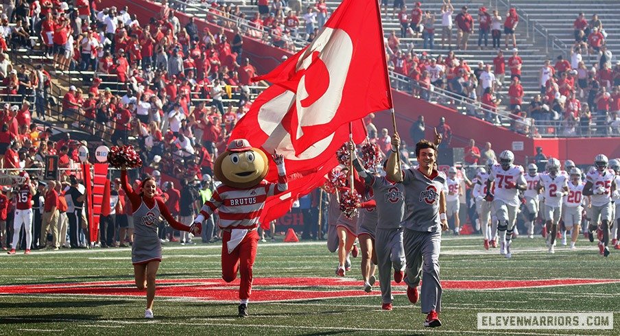 Ohio State cheerleaders run onto the field at Rutgers