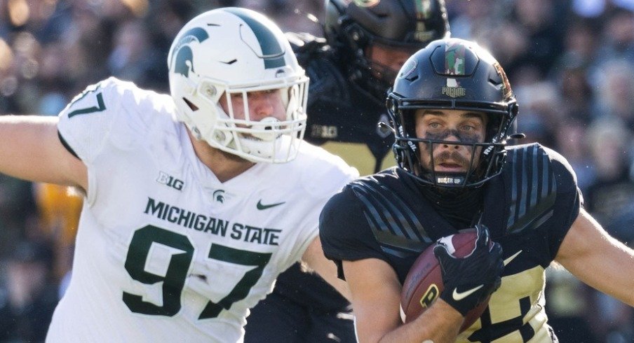 Nov 6, 2021; West Lafayette, Indiana, USA; Purdue Boilermakers wide receiver Jackson Anthrop (33) runs the ball while Michigan State Spartans defensive tackle Maverick Hansen (97) defends in the first quarter at Ross-Ade Stadium. Mandatory Credit: Trevor Ruszkowski-USA TODAY Sports