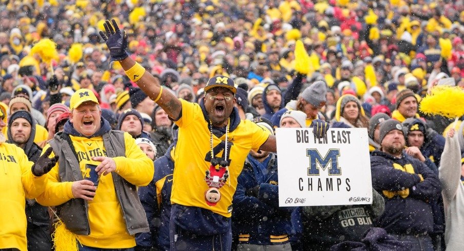 Michigan fan Gerald Blanc celebrates the Wolverines' 42-27 win over the Ohio State Buckeyes during the NCAA football game at Michigan Stadium in Ann Arbor on Saturday, Nov. 27, 2021.