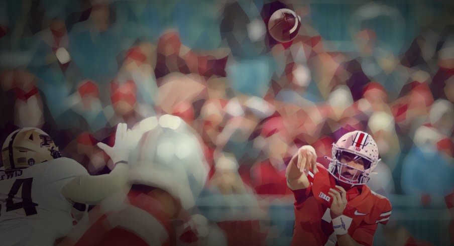 Ohio State Buckeyes quarterback C.J. Stroud (7) throws to wide receiver Chris Olave (2) during the second quarter of the NCAA football game at Ohio Stadium in Columbus on Saturday, Nov. 13, 2021.