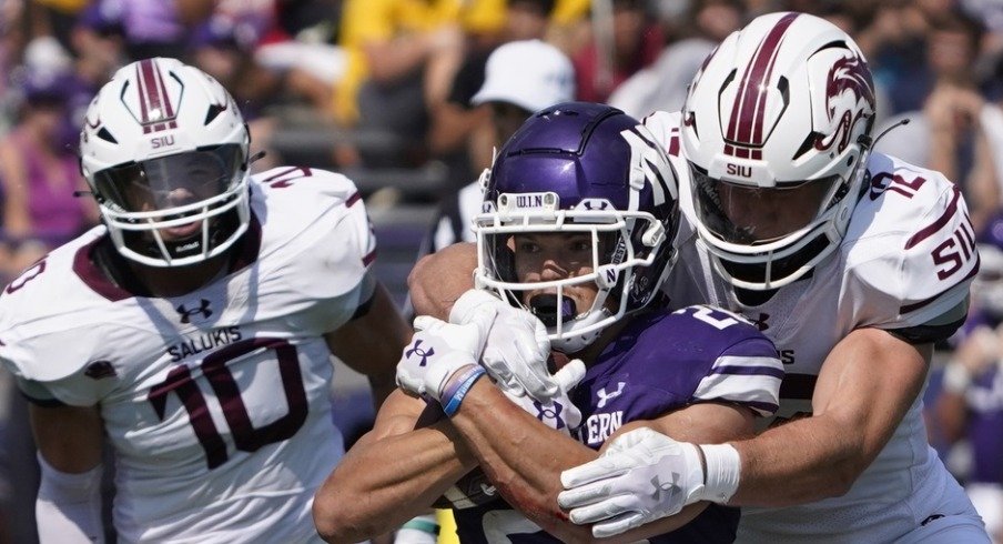 Sep 17, 2022; Evanston, Illinois, USA; Southern Illinois Salukis linebacker Branson Combs (12) tackles Northwestern Wildcats running back Evan Hull (26) during the first half at Ryan Field. Mandatory Credit: David Banks-USA TODAY Sports