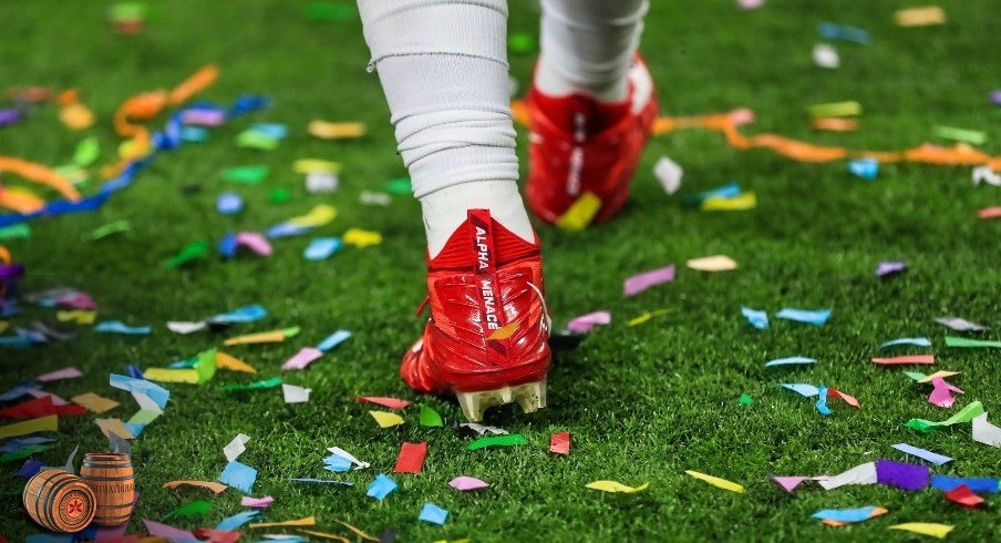 Dec 7, 2019; Indianapolis, IN, USA; A view of the Nike cleats worn by Ohio State Buckeyes defensive end Chase Young (2) as he walks through confetti after defeating the Wisconsin Badgers in the 2019 Big Ten Championship Game at Lucas Oil Stadium. Mandatory Credit: Aaron Doster-USA TODAY Sports