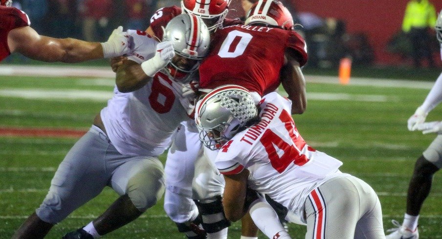 Ohio State defensive linemen Taron Vincent and J.T. Tuimoloau