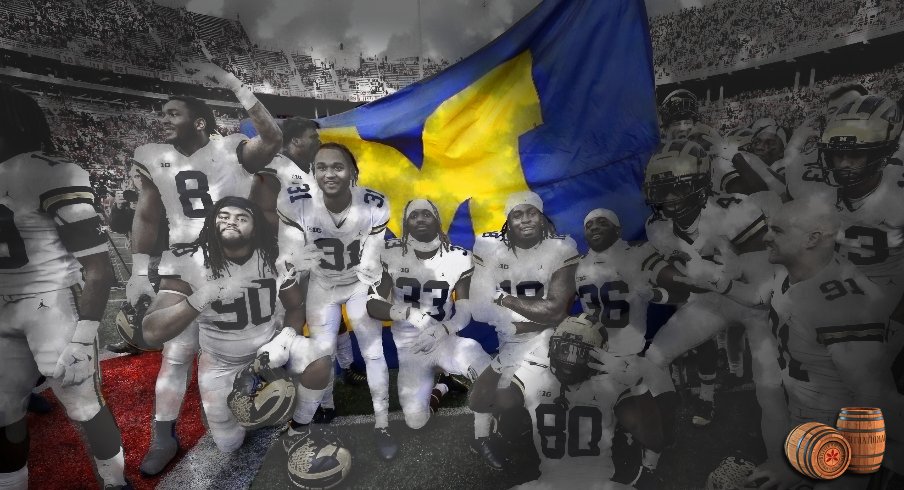 Nov 26, 2022; Columbus, Ohio, USA; Michigan Wolverines players plant the flag on the Ohio State Buckeyes fifty yard line following the win at Ohio Stadium. Mandatory Credit: © Joseph Maiorana-USA TODAY SportsJoseph Maiorana-USA TODAY Sports