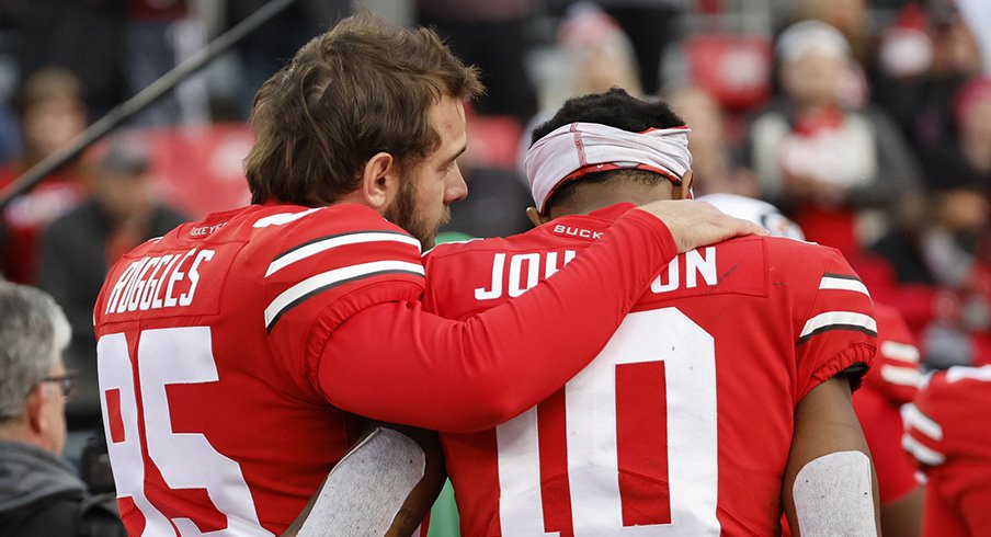 Noah Ruggles and Xavier Johnson leave the field following No. 2 Ohio State's 45-23 loss to No. 3 Michigan