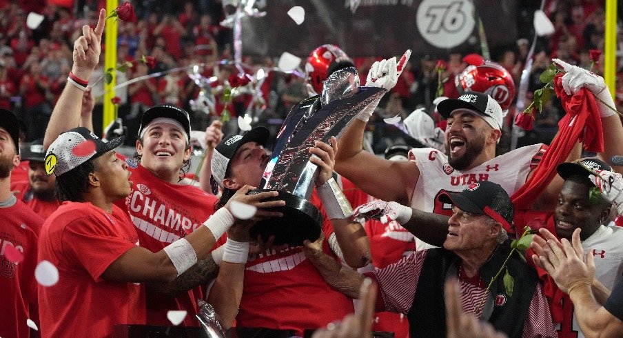 Quarterback Cameron Rising of the Utah Utes Holding the Pac-12 Championship Trophy