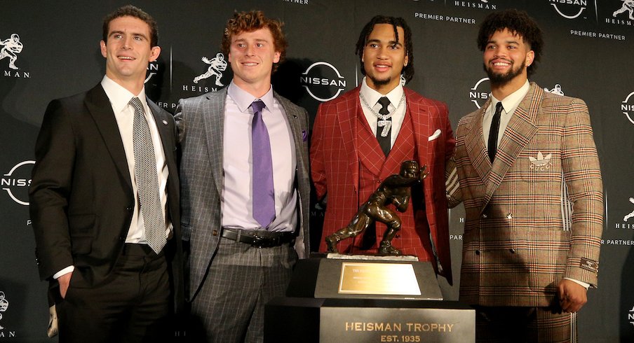 The Heisman Trophy finalists pose with the trophy.