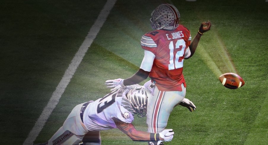 Jan 12, 2015; Arlington, TX, USA; Ohio State Buckeyes quarterback Cardale Jones (12) loses control of the ball while tackled by Oregon Ducks linebacker Tyson Coleman (33) during the third quarter in the 2015 CFP National Championship Game at AT&T Stadium. Mandatory Credit: Jerome Miron-USA TODAY Sports