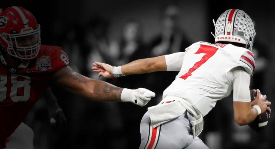 Ohio State quarterback C.J. Stroud (7) escapes a tackle from Georgia defensive lineman Jalen Carter (88) during the first half of the Chick-fil-A Peach Bowl NCAA College Football Playoff semifinal game on Saturday, Dec 31, 2022, in Atlanta. News Joshua L Jones Syndication Online Athens