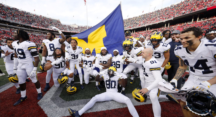Michigan players plant the flag at Ohio Stadium