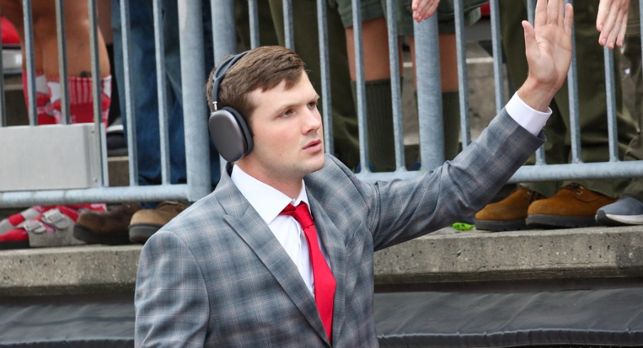 Ohio State quarterback Kyle McCord high fives fans