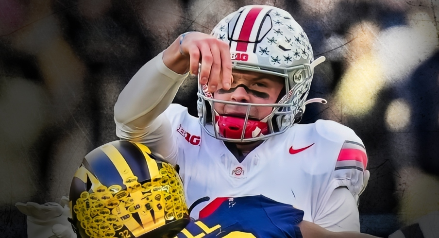 Nov 25, 2023; Ann Arbor, Michigan, USA; Ohio State Buckeyes quarterback Kyle McCord (6) is hit by Michigan Wolverines defensive end Jaylen Harrell (32) as he throws an interception during the second half of the NCAA football game at Michigan Stadium. Ohio State lost 30-24.