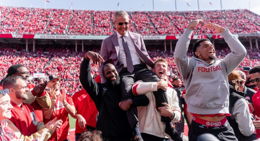 2014 National Championship team lifts Urban Meyer into the air