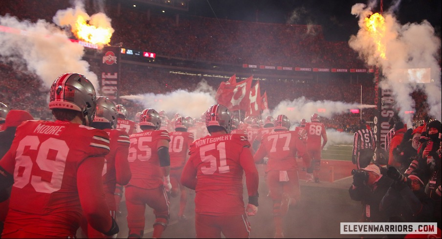 Ohio State players running into Ohio Stadium before the CFP game vs. Tennessee