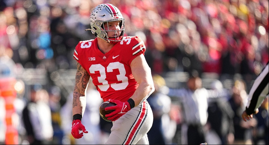 Jack Sawyer picks up a fumble vs. Michigan in 2022