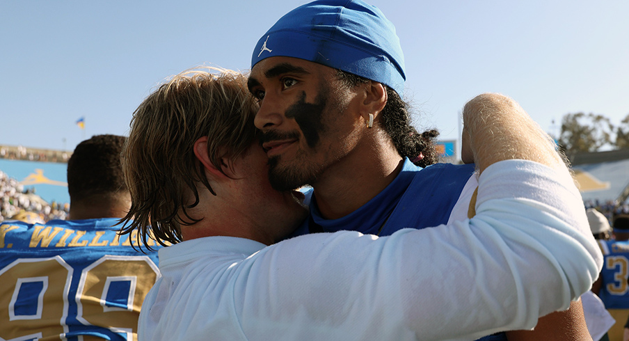 UCLA Bruins quarterback Nico Iamaleava (9,right) hugs new offensive coordinator Jerry Neuheisel after defeating the Penn State Nittany Lions 42-37 at Rose Bowl