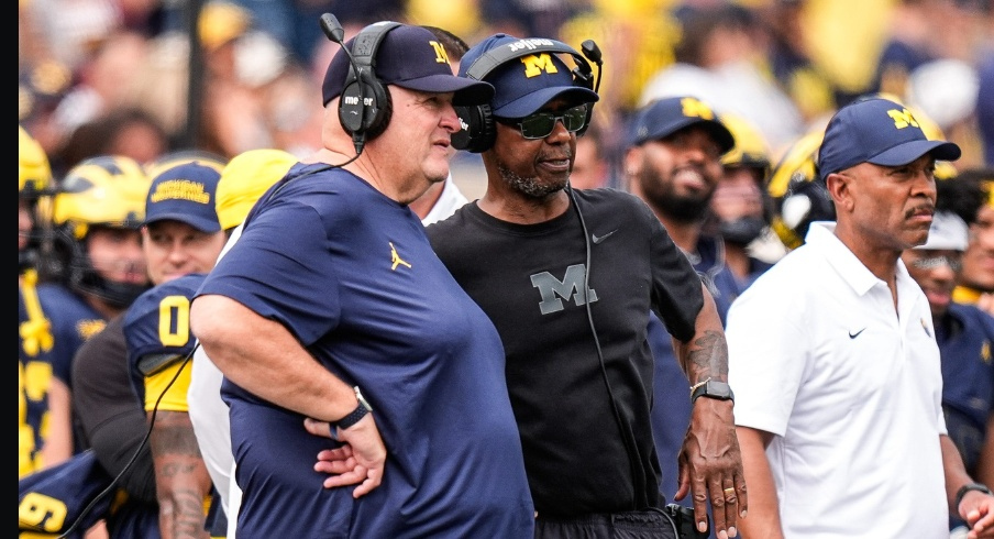 Michigan acting head coach Biff Poggi talks to senior offensive analyst Fred Jackson during the second half against Central Michigan at Michigan Stadium in Ann Arbor on Saturday, Sept. 13, 2025.