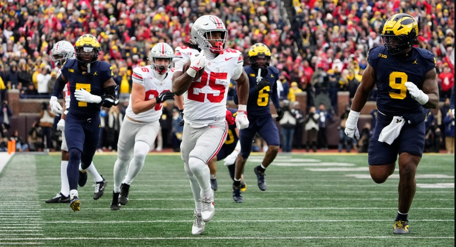 Ohio State Buckeyes running back Bo Jackson (25) runs past Michigan Wolverines defensive end Cameron Brandt (9) during the NCAA football game at Michigan Stadium in Ann Arbor, Mich. on Nov. 29, 2025. Ohio State won 27-9.