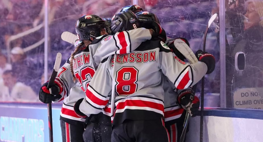 Ohio State women's hockey players embrace after a goal