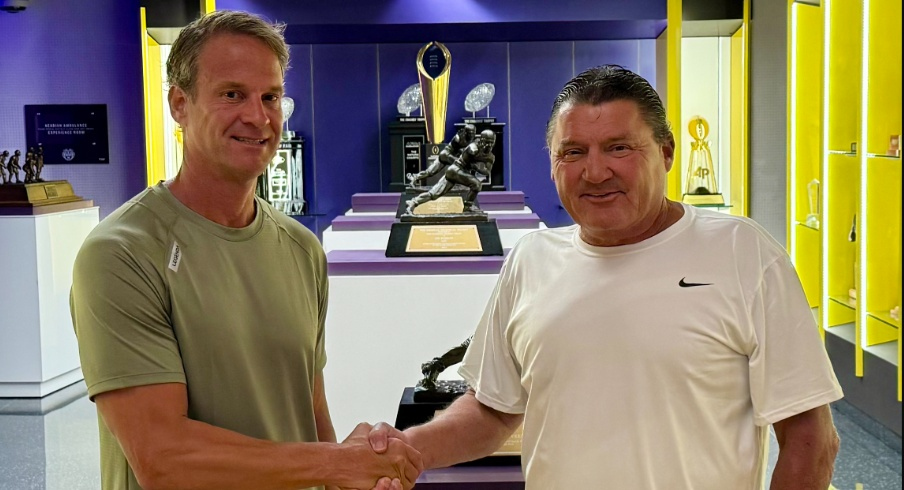 Lane Kiffin and Ed Orgeron shaking hands